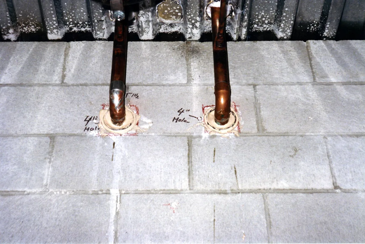 Frost-proof sillcock faucet and copper pipe fittings laid out on a workbench